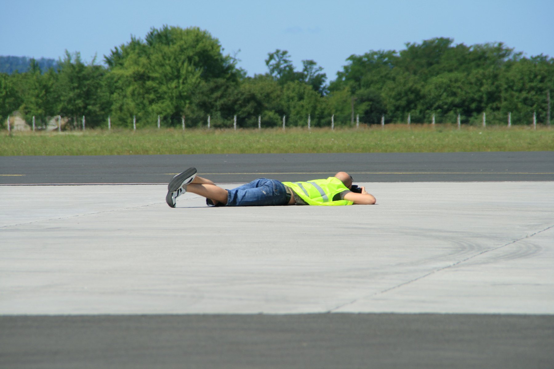 Aircraft photographer lying on the apron at Sarmellek
