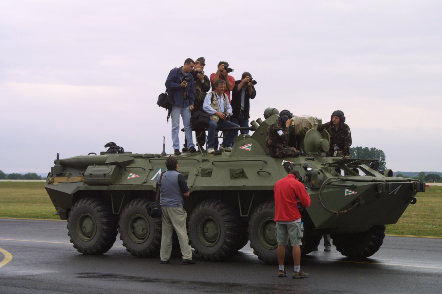 Photographers standing and sitting on a Hungarian armoured vehicle at Taszár Air Base